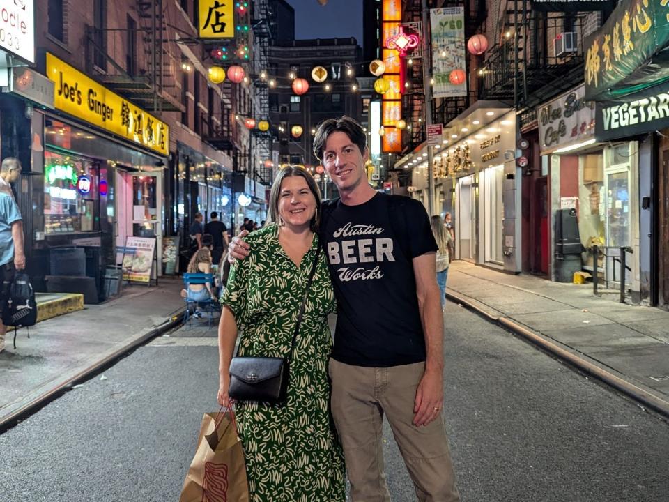 Katrina Donham and her husband standing on a New York City street at night.