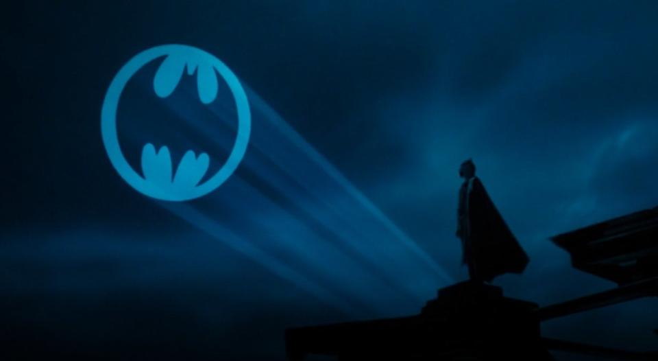 Batman staring up at the Bat-signal in the sky in "Batman"