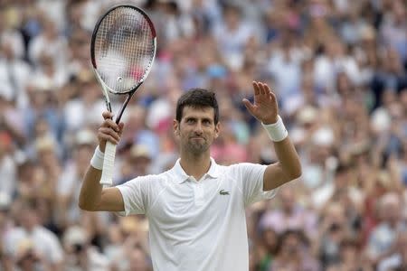 Jul 14, 2018; London, United Kingdom; Novak Djokovic (SRB) celebrates match point during his match against Rafael Nadal (ESP) on day 12 at All England Lawn and Croquet Club. Mandatory Credit: Susan Mullane-USA TODAY Sports