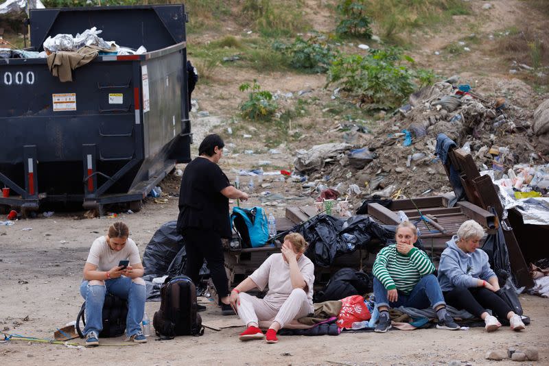 Migrants wait between border fences of U.S. and Mexico in California