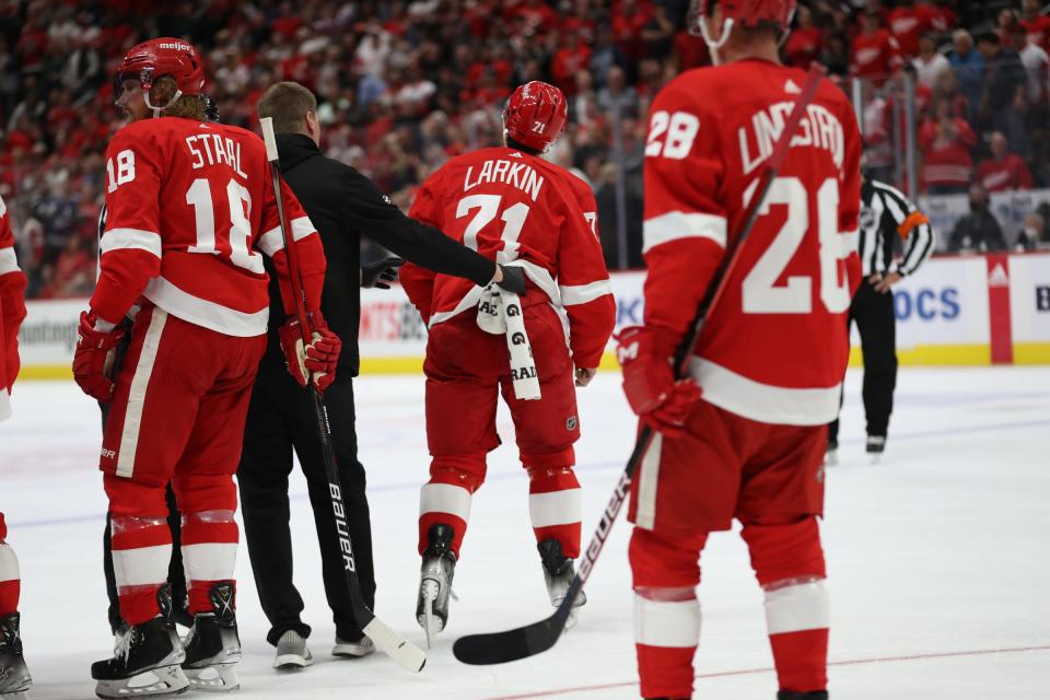 Detroit Red Wings center Dylan Larkin (71) is taken off the ice after punching Tampa Bay Lightning right wing Mathieu Joseph (7) during second-period action of the season opener at Little Caesars Arena Thursday, Oct. 14, 2021.