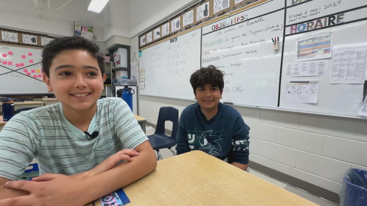 Zane Bassam and Tony Elsoury, two Grade 6 students at École élémentaire catholique Sainte-Thérèse. Zane was able to help Tony when he was choking thanks to first-aid training the students received in class.  (Meg Roberts/CBC - image credit)