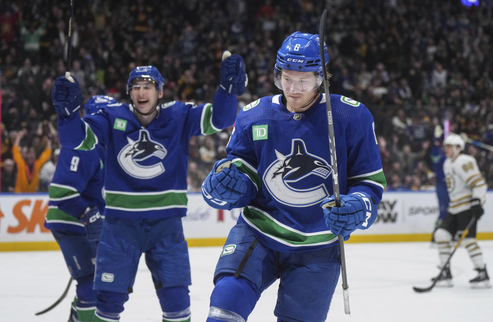 Vancouver Canucks' Brock Boeser, front right, and Ilya Mikheyev, left, celebrate after Boeser's goal against the Boston Bruins during the third period of an NHL hockey game in Vancouver, British Columbia, Saturday, Feb. 24, 2024. (Darryl Dyck/The Canadian Press via AP)