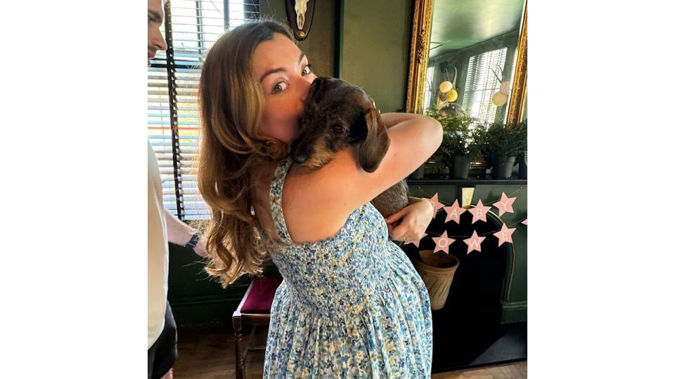 The mother-to-be looked beautiful as she cuddled her dog Ruby