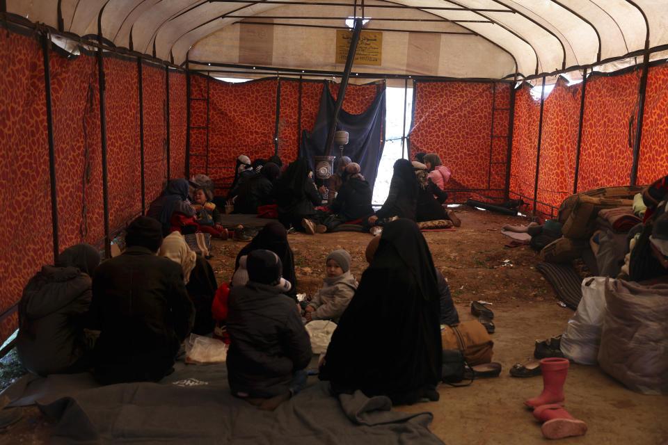 <p>Families who lost their homes in a devastating earthquake in Syria sit inside a tent that an NGO set up to provide them shelter and food in the town of Harem near the Turkish border, Idlib province, Syria, Wednesday, Feb. 8, 2023. With the hope of finding survivors fading, stretched rescue teams in Turkey and Syria searched Wednesday for signs of life in the rubble of thousands of buildings toppled by a catastrophic earthquake. (AP Photo/Ghaith Alsayed)</p> 