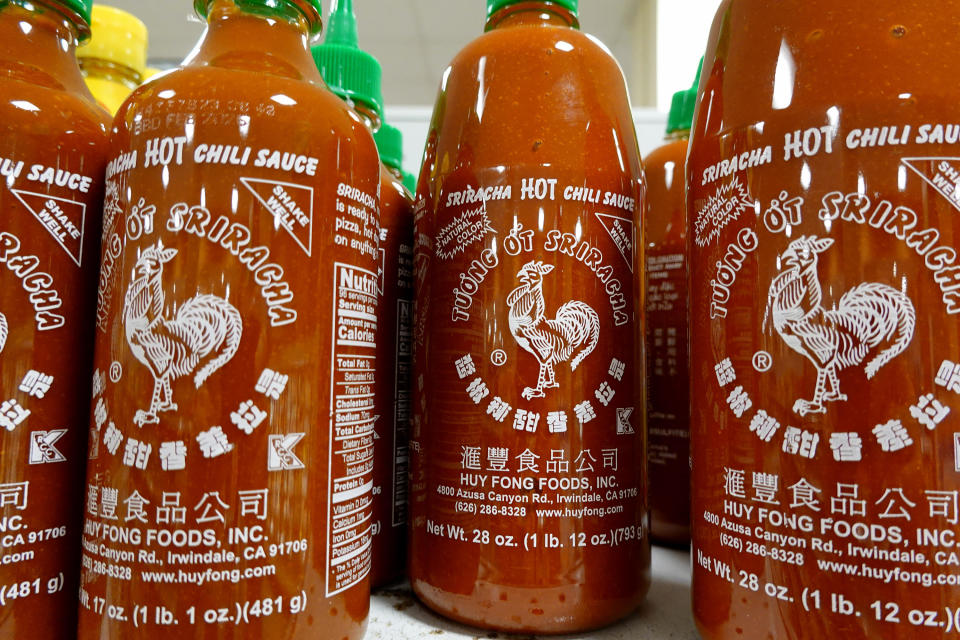 Bottles of Huy Fong Foods Sriracha line a grocery store shelf on May 10, 2024 in Miami, Florida.  / Credit: Joe Raedle/Getty Images