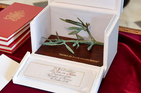 An olive twig as a symbol for peace is Pope Francis' gift to South Korean President Moon Jae-in during a private audience at the Vatican, October 18, 2018. Alessandro Di Meo/ Pool via Reuters