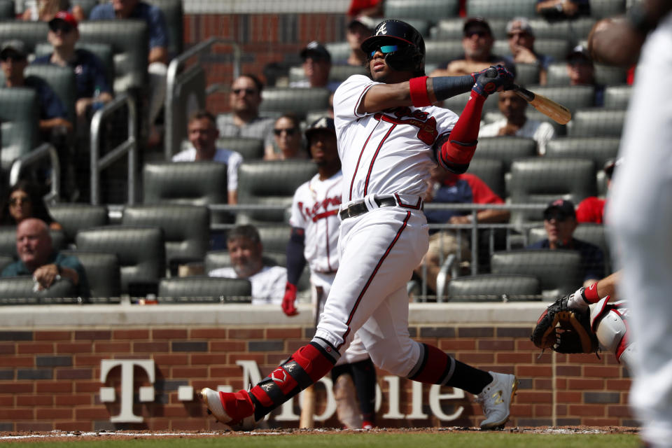 Atlanta Braves center fielder Ronald Acuna Jr. (13) follows through on a solo home run in the third inning of a baseball game against the Philadelphia Phillies Thursday, Sept. 19, 2019, in Atlanta. The homer was Acuna's 40th of the season. (AP Photo/John Bazemore)