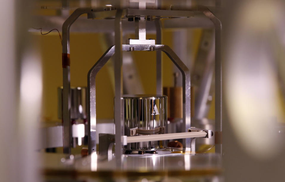 In this photo taken Wednesday, Oct. 17, 2018, a weight is set up at the International Bureau of Weights and Measures, in Sevres, near Paris. The golf ball-sized metal cylinder at the heart of the world's system for measuring mass is heading into retirement. Gathering this week in Versailles, west of Paris, governments on Friday Nov. 16, 2018, are expected to approve a plan to instead use a scientific formula to define the exact weight of a kilo. (AP Photo/Christophe Ena)