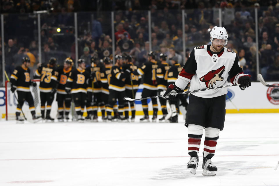 Arizona Coyotes' Phil Kessel skates to the locker room as the Boston Bruins congratulate each other after their win in an NHL hockey game Saturday, Feb. 8, 2020, in Boston. (AP Photo/Winslow Townson)