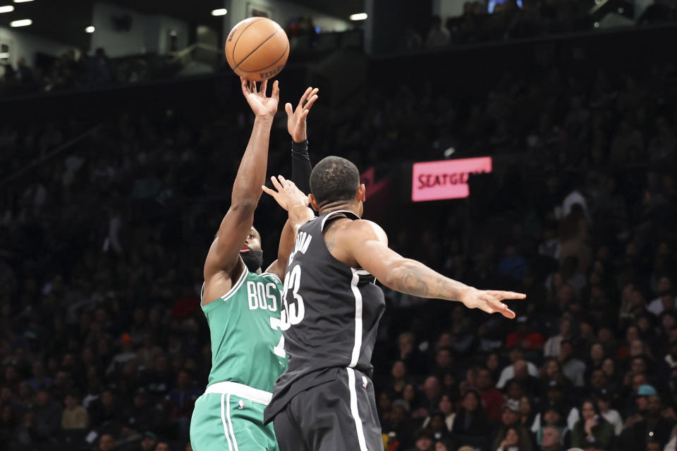 Boston Celtics guard Jaylen Brown shoots against Brooklyn Nets forward Nic Claxton during the first half of an NBA basketball game, Sunday, Dec. 4, 2022, in New York. (AP Photo/Jessie Alcheh)