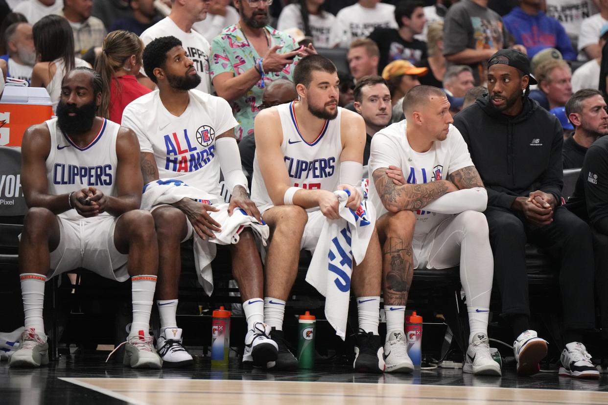 James Harden, Paul George, Ivica Zubac, Daniel Theis and Kawhi Leonard sit on the bench during the second half of Game 5 against the Mavericks.