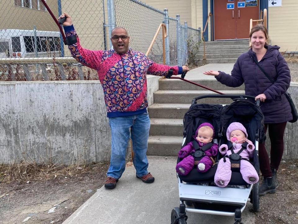 Ramesh Ferris, left, was frustrated to find a flight of stairs to negotiate when he went to vote in Whitehorse's city election. He found a woman with a stroller, also having a hard time. Ferris said the city should do better to ensure all polling places are accessible. (Submitted by Ramesh Ferris - image credit)