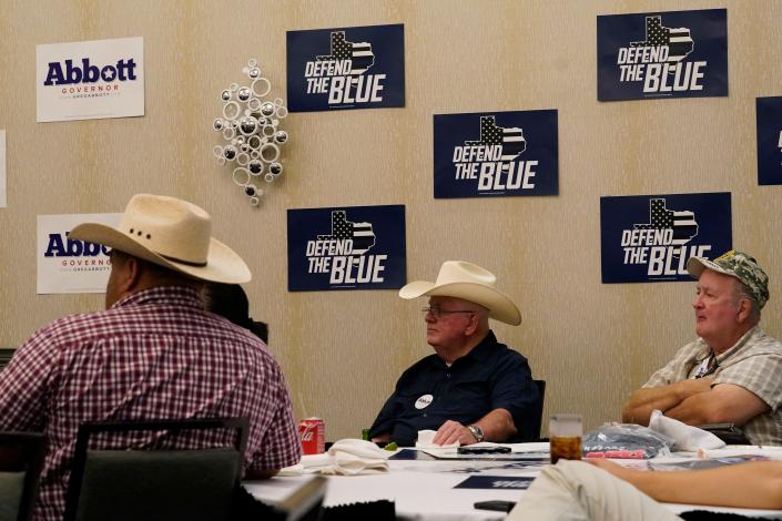 Supporters of Texas Gov. Greg Abbott watch his debate with Texas Democratic gubernatorial candidate Beto O'Rourke, Friday, Sept. 30, 2022, in McAllen, Texas.