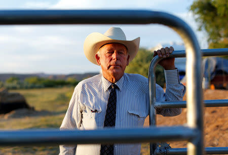 FILE PHOTO: Rancher Cliven Bundy stands near a cattle gate on his 160 acre ranch in Bunkerville, Nevada May 3, 2014. REUTERS/Mike Blake/File Photo