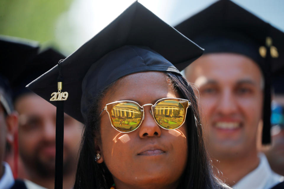 A graduating student listens as former New York City Mayor Michael Bloomberg delivers the Commencement Address during Commencement Exercises at the Massachusetts Institute of Technology (MIT) in Cambridge, Massachusetts, U.S., June 7, 2019.   REUTERS/Brian Snyder     TPX IMAGES OF THE DAY