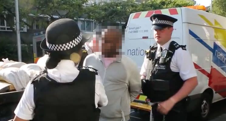 The man is arrested outside Grenfell tower block (YouTube screengrab)