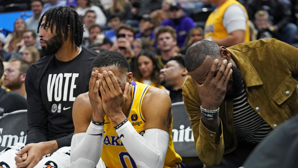 Los Angeles Lakers' Anthony Davis, Russell Westbrook and LeBron James sit on the bench near the end of their game against the Utah Jazz on Nov. 7, 2022, in Salt Lake City. (AP Photo/Rick Bowmer)