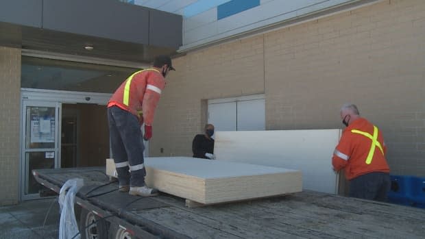 Crews working Tuesday to prepare the Windsor International Aquatic and Training Centre as an emergency shelter. (Jacob Barker/CBC - image credit)