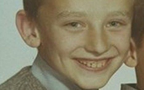 A young Boy George grins for a school photo