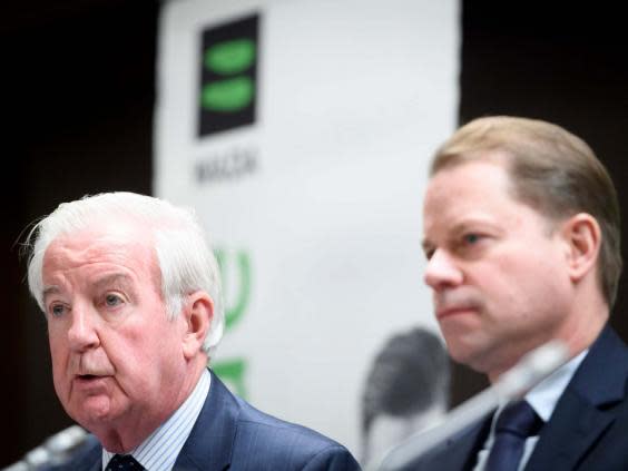 Wada president Craig Reedie, left, and director general Olivier Niggli speak during a press conference announcing Russia's ban (AP)