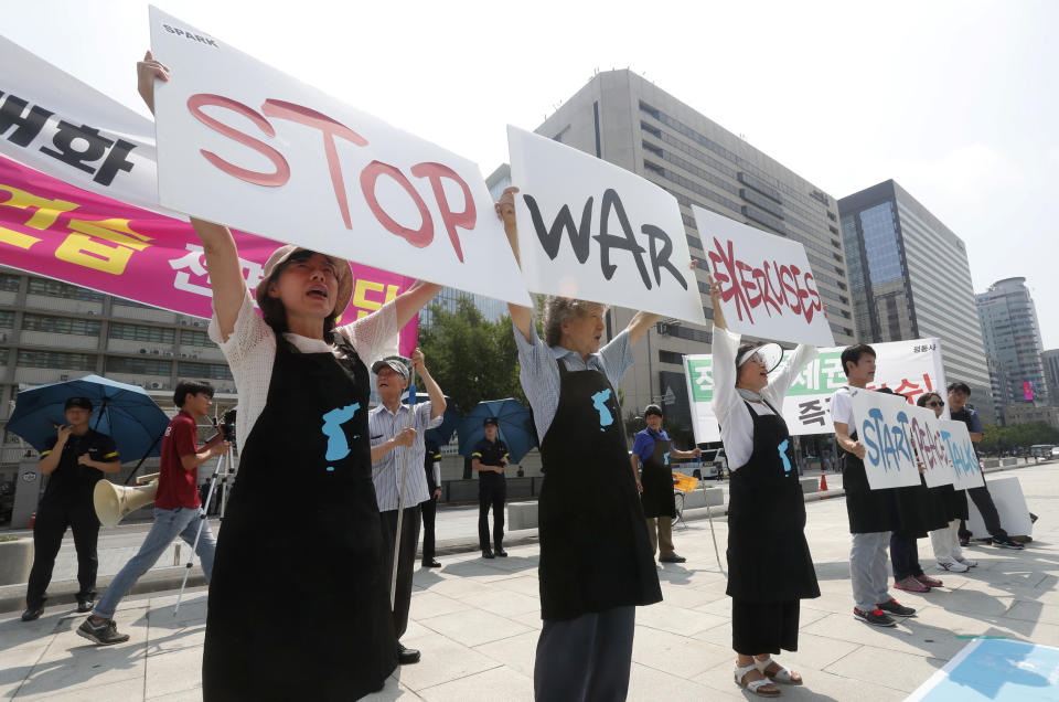 Protesters hold up placards to oppose planned joint military exercises between South Korea and the United States near the U.S. embassy in Seoul, South Korea, Monday, Aug. 5, 2019. The both countries are preparing to hold their annual joint military exercises despite warnings from North Korea that the drills could derail the fragile nuclear diplomacy, Seoul's military said Friday. (AP Photo/Ahn Young-joon)