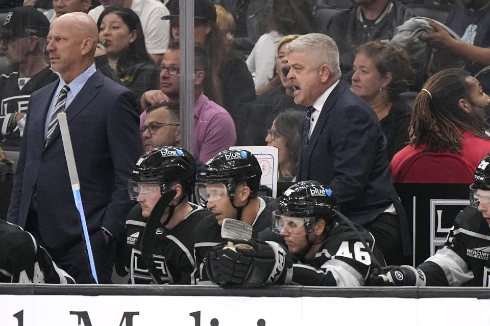 Los Angeles Kings head coach Todd McLellan, right, yells to his team during the second period of an NHL hockey game against the Carolina Hurricanes Saturday, Oct. 14, 2023, in Los Angeles. (AP Photo/Mark J. Terrill)