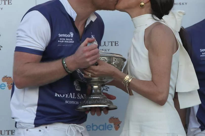 The Duchess of Sussex presents the trophy to her husband, the Duke of Sussex after his team the Royal Salute Sentebale Team defeated the Grand Champions Team, in the Royal Salute Polo Challenge, to benefit Sentebale, at The USPA National Polo Center in Wellington, Florida, US. Picture date: Friday April 12, 2024. PA Photo. Photo credit should read: Yaroslav Sabitov/PA Wire