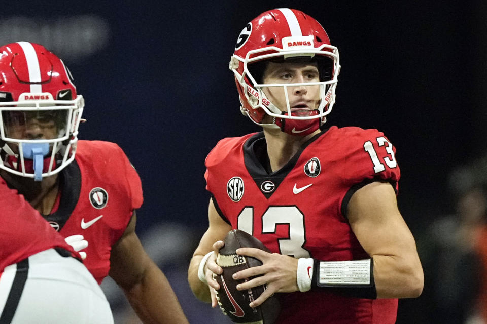 FILE - Georgia quarterback Stetson Bennett (13) looks for an open receiver in the first half of the Southeastern conference championship NCAA college football game against the LSU, on Dec. 3, 2022 in Atlanta. Former walk-on Stetson Bennett, who threw four TD passes in No. 1 Georgia's SEC championship game win over LSU, continues to thrive in the postseason. (AP Photo/John Bazemore, File)