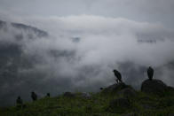 Rain clouds hover over mountains during tropical storm Amanda in Barberena, eastern Guatemala, Sunday, May 31, 2020. The first tropical storm of the Eastern Pacific season drenched parts of Central America on Sunday and officials in El Salvador said at least seven people had died in flooding. (AP Photo/Moises Castillo)