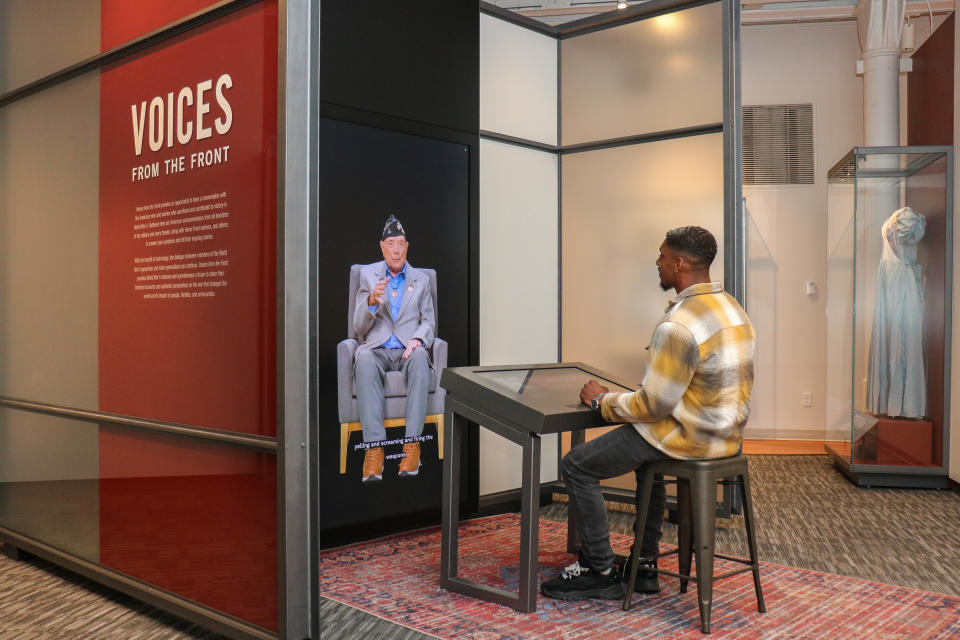 Devin Dumas speaks with a video image of the late World War II veteran Hershel “Woody” Williams as part of the new Voices From the Front exhibit at the National WWII Museum in New Orleans. (La'Shance Perry)