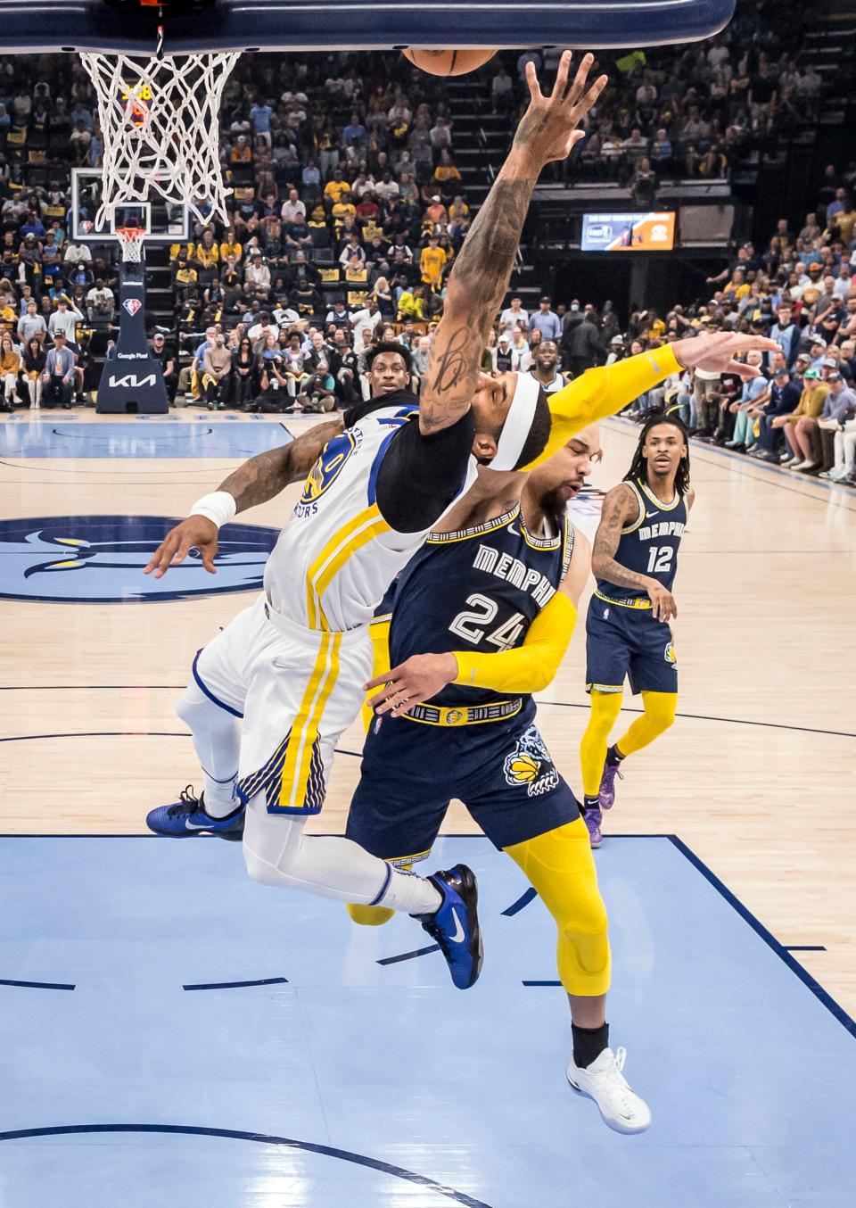 Gary Payton II (0) falls to the ground after being hit in the head from behind by Dillon Brooks (24) in was was deemed a flagrant two foul in the first quarter as the Golden State Warriors played the Memphis Grizzlies in Game 2 of the second round of the NBA Playoffs at Fedex Forum in Memphis, Tenn., on Tuesday, May 3, 2022. The Warriors lost to the Grizzlies 106-101 to even the series 1-1.(Carlos Avila Gonzalez/San Francisco Chronicle via AP)