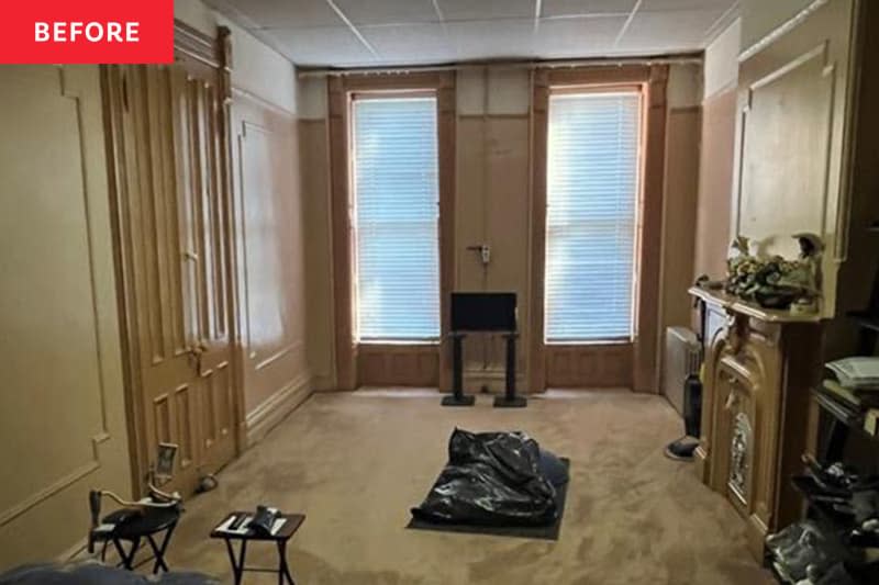 Fireplace in carpeted living room before renovation.