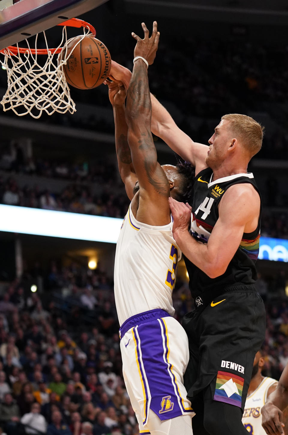 Denver Nuggets forward Mason Plumlee (24) knocks the ball from the hands of Los Angeles Lakers center Dwight Howard (39) during the second quarter an NBA basketball game Tuesday, Dec. 3, 2019, in Denver. (AP Photo/Jack Dempsey)