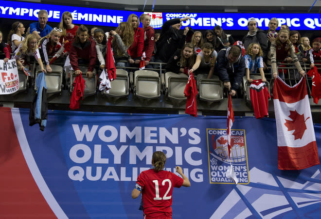 VANCOUVER, CANADA - JANUARY 29: Christine Sinclair #12 of Canada signs autographs for fans after the championship game of the 2012 CONCACAF Women's Olympic Qualifying Tournament against the United Sates at BC Place on January 29, 2012 in Vancouver, British Columbia, Canada. (Photo by Rich Lam/Getty Images)