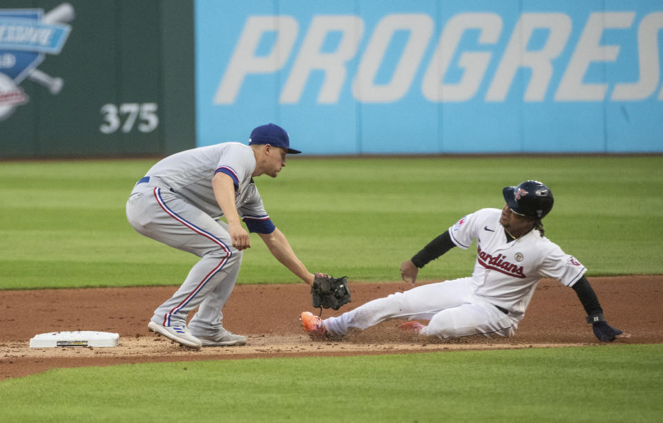 Texas Rangers' Corey Seager, left, tags out Cleveland Guardians' Jose Ramirez at second base on a steal attempt during the first inning of a baseball game in Cleveland on Friday, Sept. 15, 2023. (AP Photo/Phil Long)