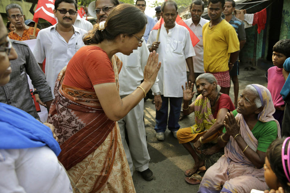 Communist Party of India (Marxist) candidate Nandini Mukherjee, center, seeks votes in a slum area in Kolkata, India, Thursday, April 10, 2014. Millions of people are voting in the third phase of the elections Thursday, covering parts of 11 of India's 28 states. The multiphase voting across the country runs until May 12, with results for the 543-seat lower house of parliament announced May 16. (AP Photo/Bikas Das)