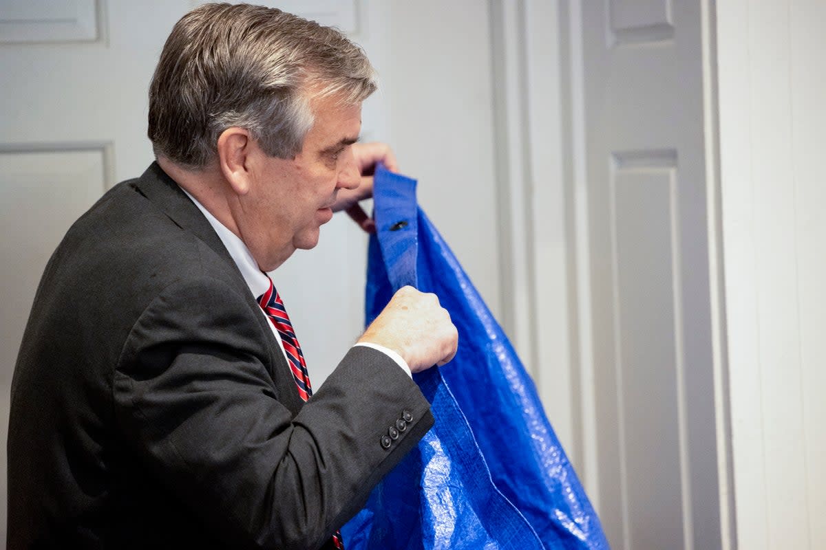 Prosecutor holds up blue tarp during trial (AP)