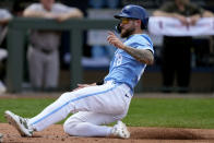 Kansas City Royals' Kyle Isbel slides home to score on a ground out hit into by Maikel Garcia during the sixth inning of a baseball game against the Oakland Athletics Sunday, May 19, 2024, in Kansas City, Mo. (AP Photo/Charlie Riedel)