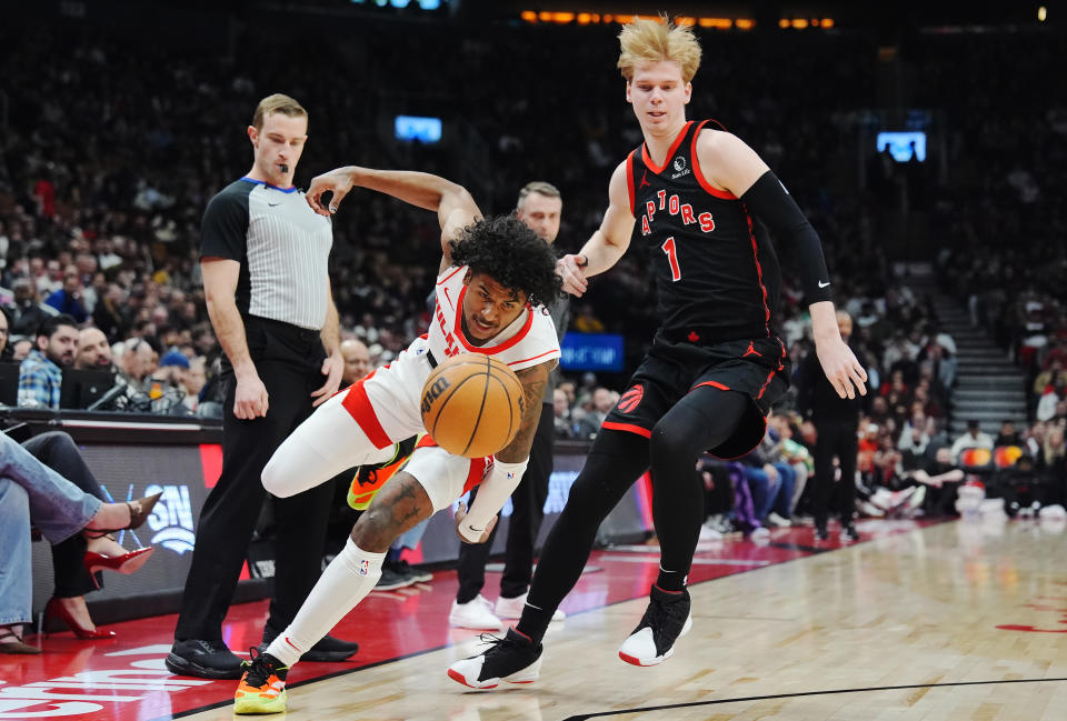 Houston Rockets forward Amen Thompson, left, tries to get around Toronto Raptors guard Gradey Dick (1) during the first half of an NBA basketball game Friday, Feb. 9, 2024, in Toronto. (Frank Gunn/The Canadian Press via AP)