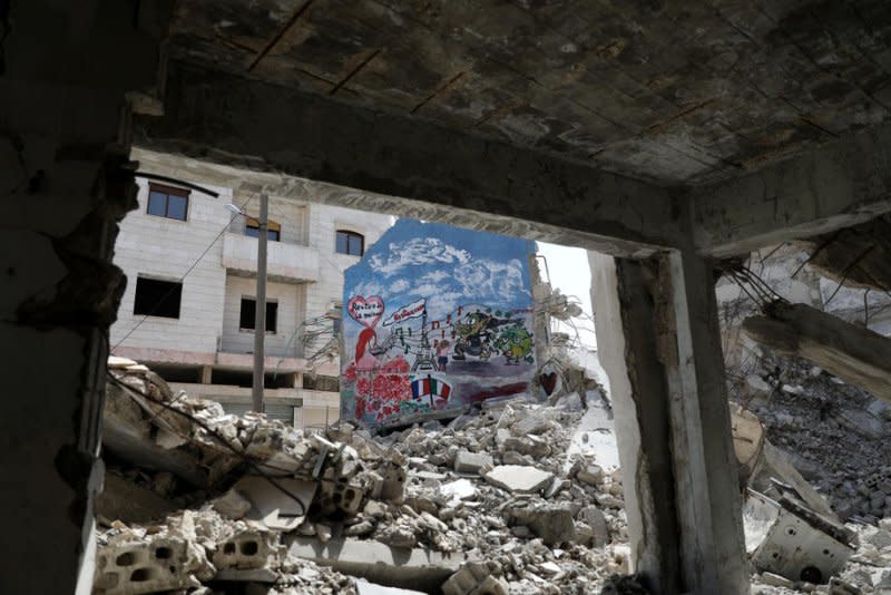 Graffiti is painted on damaged building in Idlib, Syria, in 2020. File Photo by Yahya Nemah/EPA-EFE