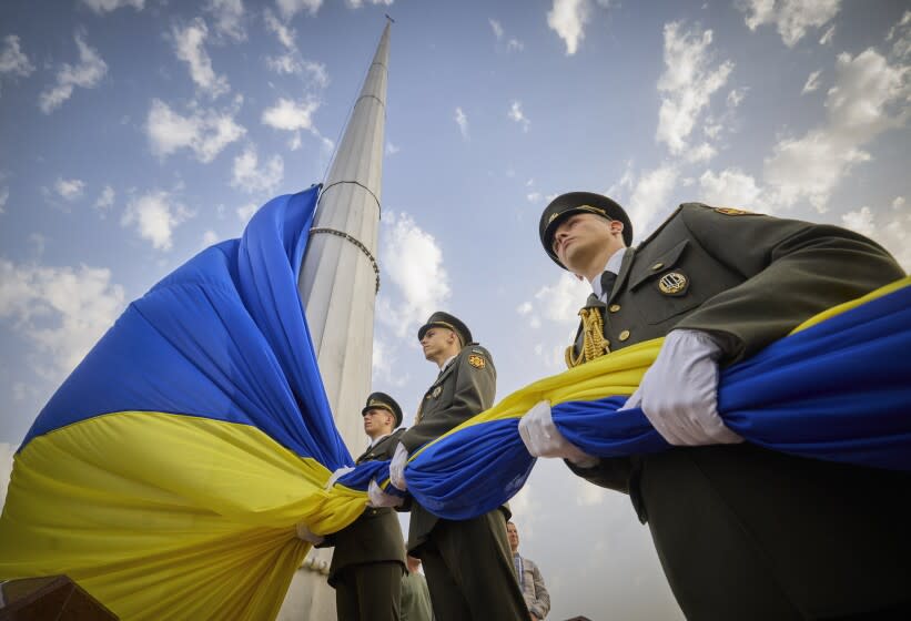 In this photo provided by the Ukrainian Presidential Press Office, honour guard soldiers prepare to rise the Ukrainian national flag during State Flag Day celebrations in Kyiv, Ukraine, Tuesday, Aug. 23, 2022. (Ukrainian Presidential Press Office via AP)