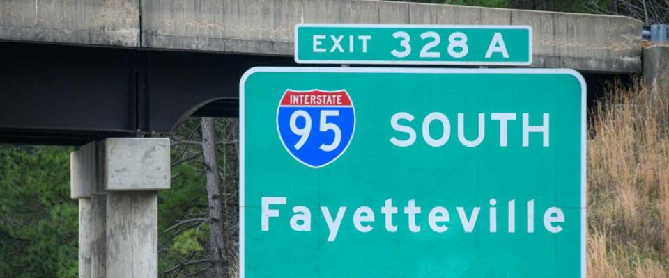 A highway sign leads drivers to Fort Bragg in Fayetteville, NC, USA.