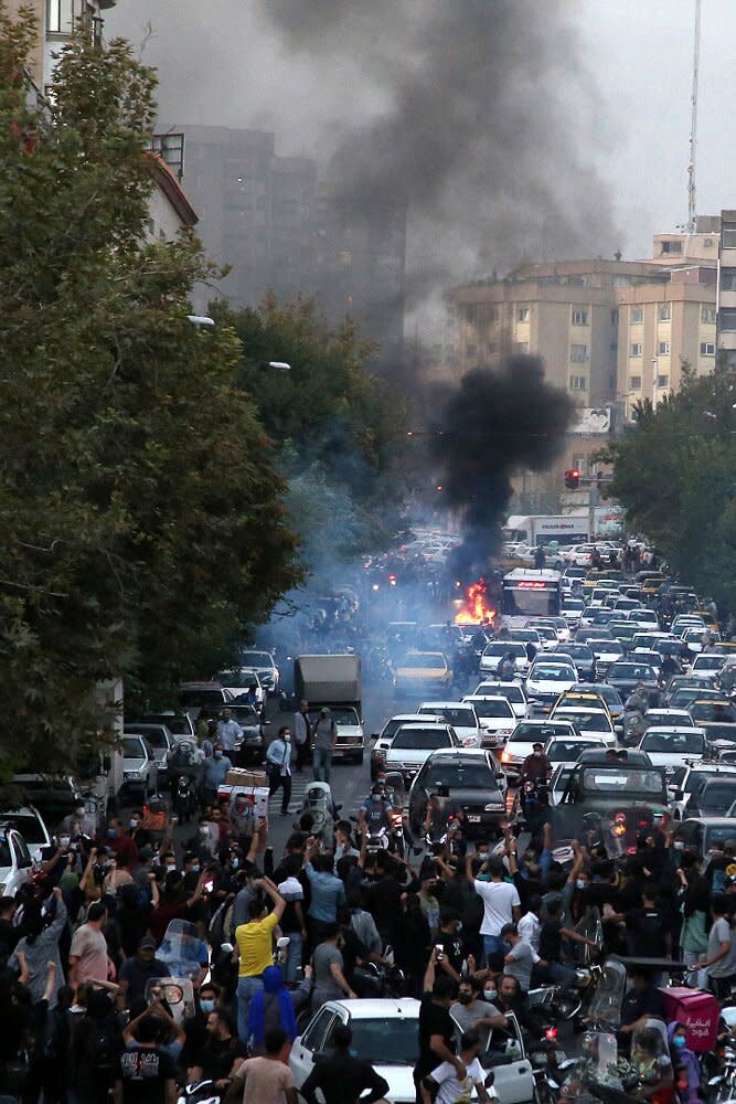 A picture obtained by AFP outside Iran on September 21, 2022, shows Iranian demonstrators taking to the streets of the capital Tehran during a protest for Mahsa Amini, days after she died in police custody. - Protests spread to 15 cities across Iran overnight over the death of the young woman Mahsa Amini after her arrest by the country's morality police, state media reported today.In the fifth night of street rallies, police used tear gas and made arrests to disperse crowds of up to 1,000 people, the official IRNA news agency said.
