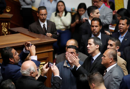 Venezuelan opposition leader and self-proclaimed interim president Juan Guaido applauds as he attends a session of the Venezuela's National Assembly in Caracas, Venezuela January 29, 2019. REUTERS/Carlos Garcia Rawlins