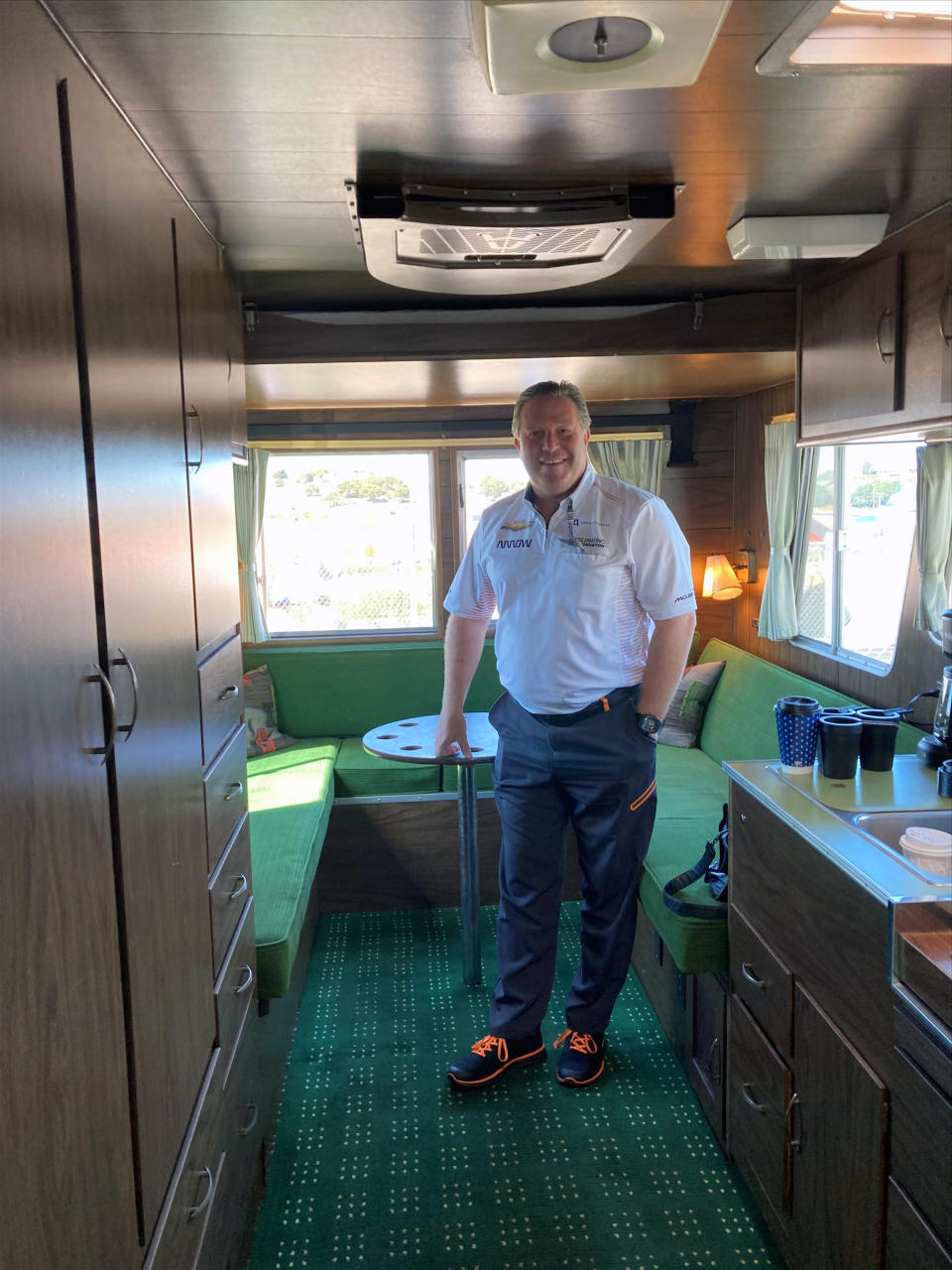 McLaren CEO Zak Brown poses is his office, a 1972 Ford Condor RV he purchased in an online auction, at Laguna Seca Raceway in Monterey, Calif., Sunday, Sept. 19, 2021. What does champagne taste like when chugged from a dirty shoe? Zak Brown doesn't know the answer to the question he's been most asked since McLaren broke a nine-year Formula One losing streak with a 1-2 sweep in Italy. Daniel Ricciardo celebrates his victories with a “shoey” in which he fills his racing boot with champagne and turns the podium into a party. (AP Photo/Jenna Fryer)