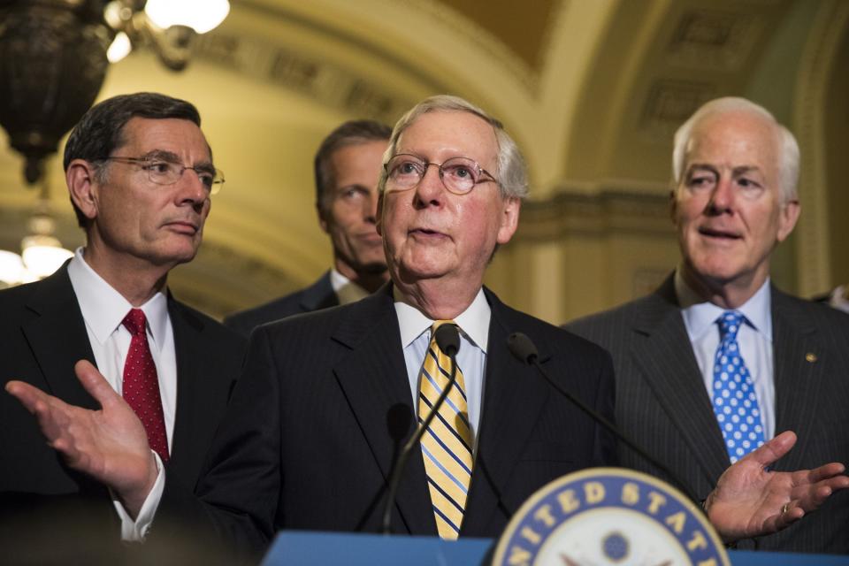 Senate Majority Leader Mitch McConnell, center, speaks alongside Sens. John Barrasso, left, John Cornyn, right, and John Thune, rear, after the Senate narrowly passed the motion to proceed for the replacement of the Affordable Care Act on July 25, 2017.