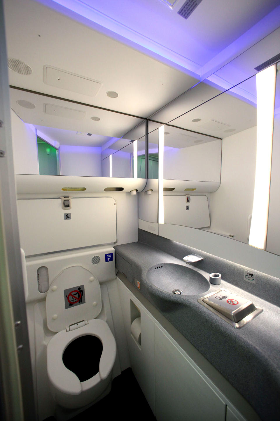 A restroom is seen with some of the variable lighting available on the new Boeing 747-8 Intercontinental before delivery by Boeing to Lufthansa Tuesday, May 1, 2012, in Everett, Wash. Lufthansa is the launch customer for the Intercontinental and will start service with the airplane between Frankfurt, Germany and Washington, D.C. The 747-8 Intercontinental is a stretched, updated version of the iconic 747 and is expected to bring double-digit improvements in fuel burn and emissions over its predecessor, the 747-400, and generate 30 percent less noise. Boeing delivered the first 747-8 Intercontinental to a private customer in February, more than a year after originally planned. (AP Photo/Elaine Thompson)