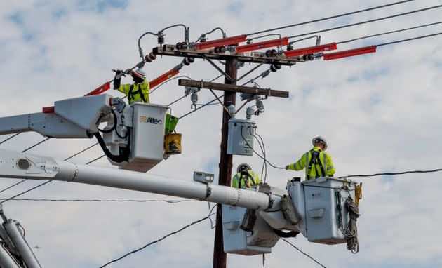 Workers with Southern California Edison replace a transformer on Holt Street in Santa Ana, California, on Sept. 10, 2021, after an evening of lightning storms.