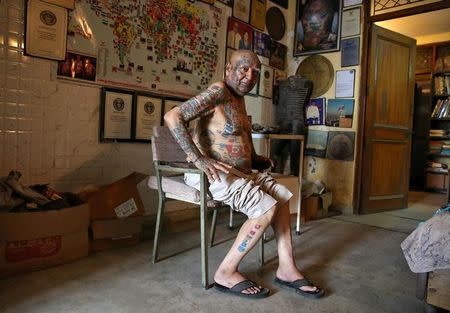 Guinness Rishi, 74, multiple world record holder including most flags tattooed on his body, is pictured inside his apartment in New Delhi, India May 20, 2016. REUTERS/Cathal McNaughton